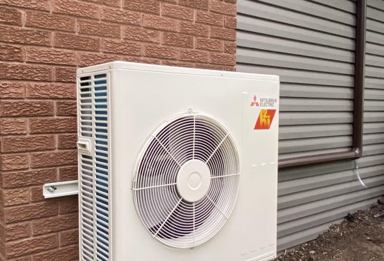 Technician installing a high-efficiency heat pump in Mississauga, ON